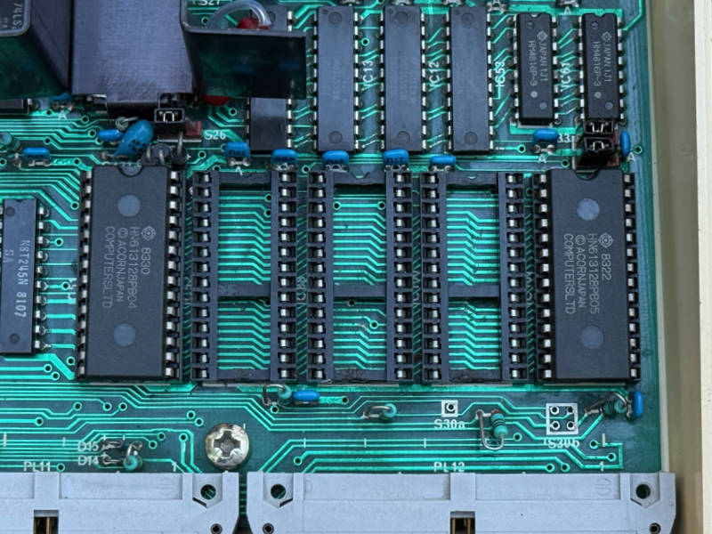 OS 1.2 and Basic 2 are definitely not original. Damage to the three sockets between them shows other ROMs were fitted then removed